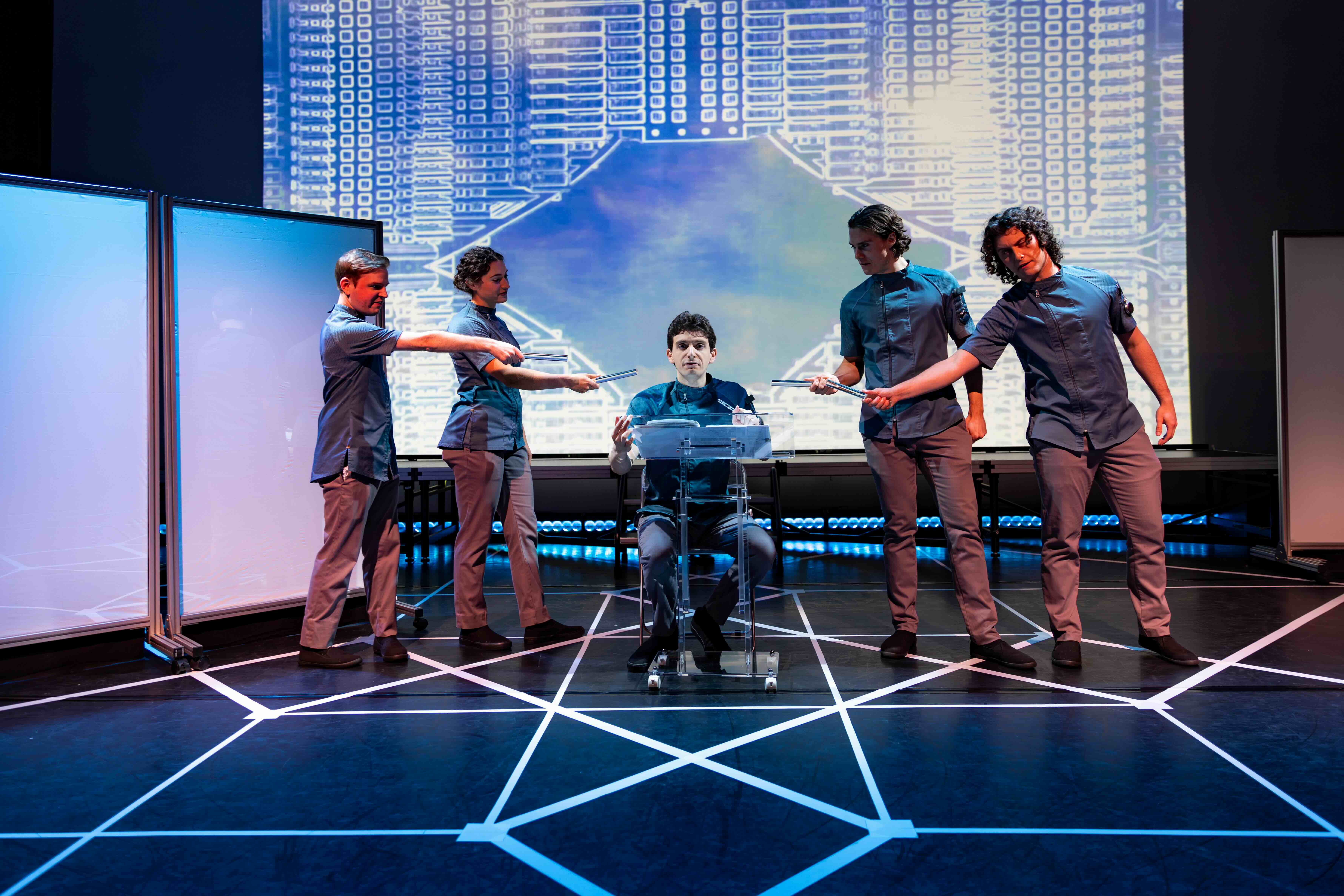  John Teresi and Rachel Fink as MEDIA, Aaron Greenberg as D-503, Crosby Lloyd and Nathan Reder as MEDIA. 