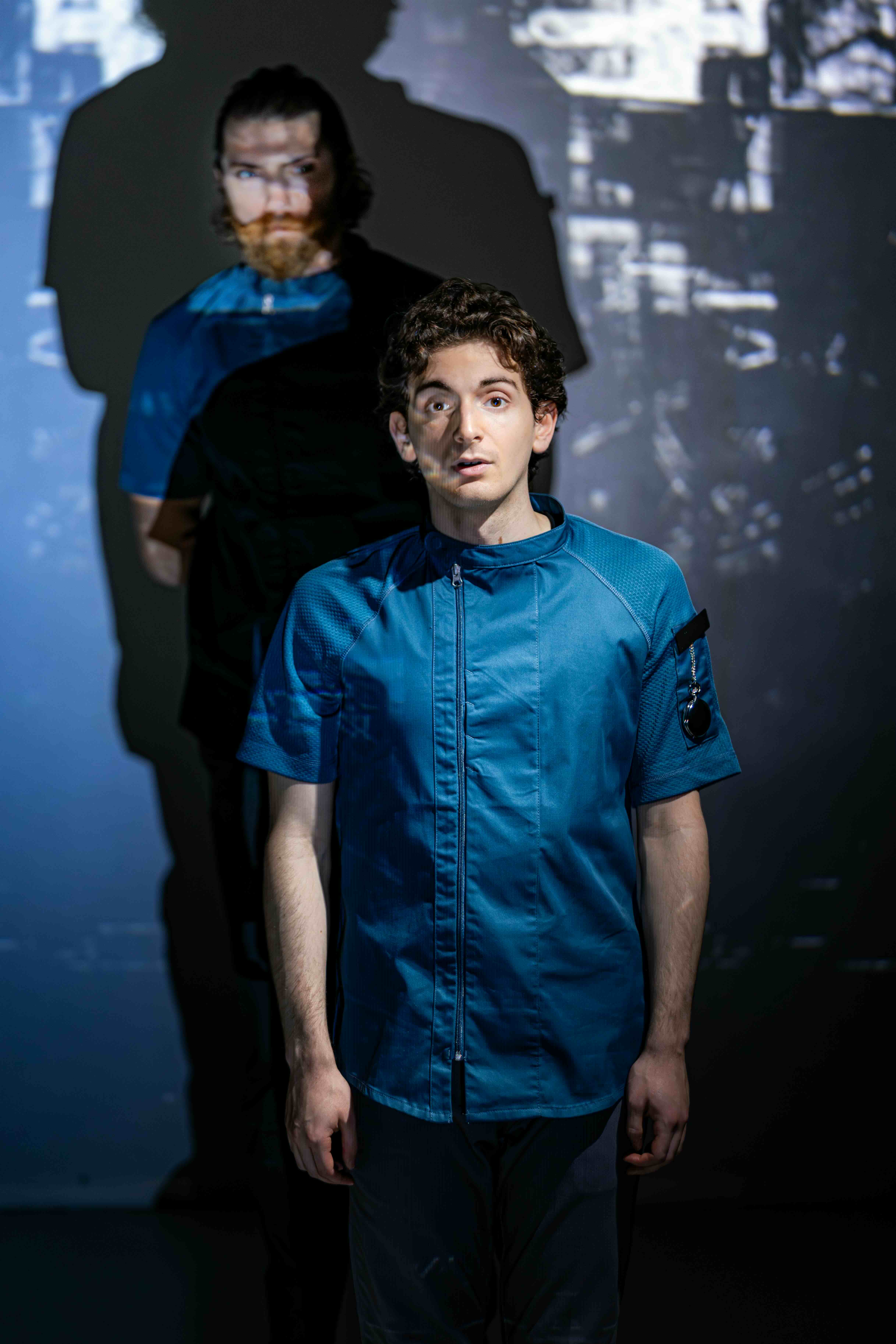  Ian Cramer as S-4711 and Aaron Greenberg as D-503. 