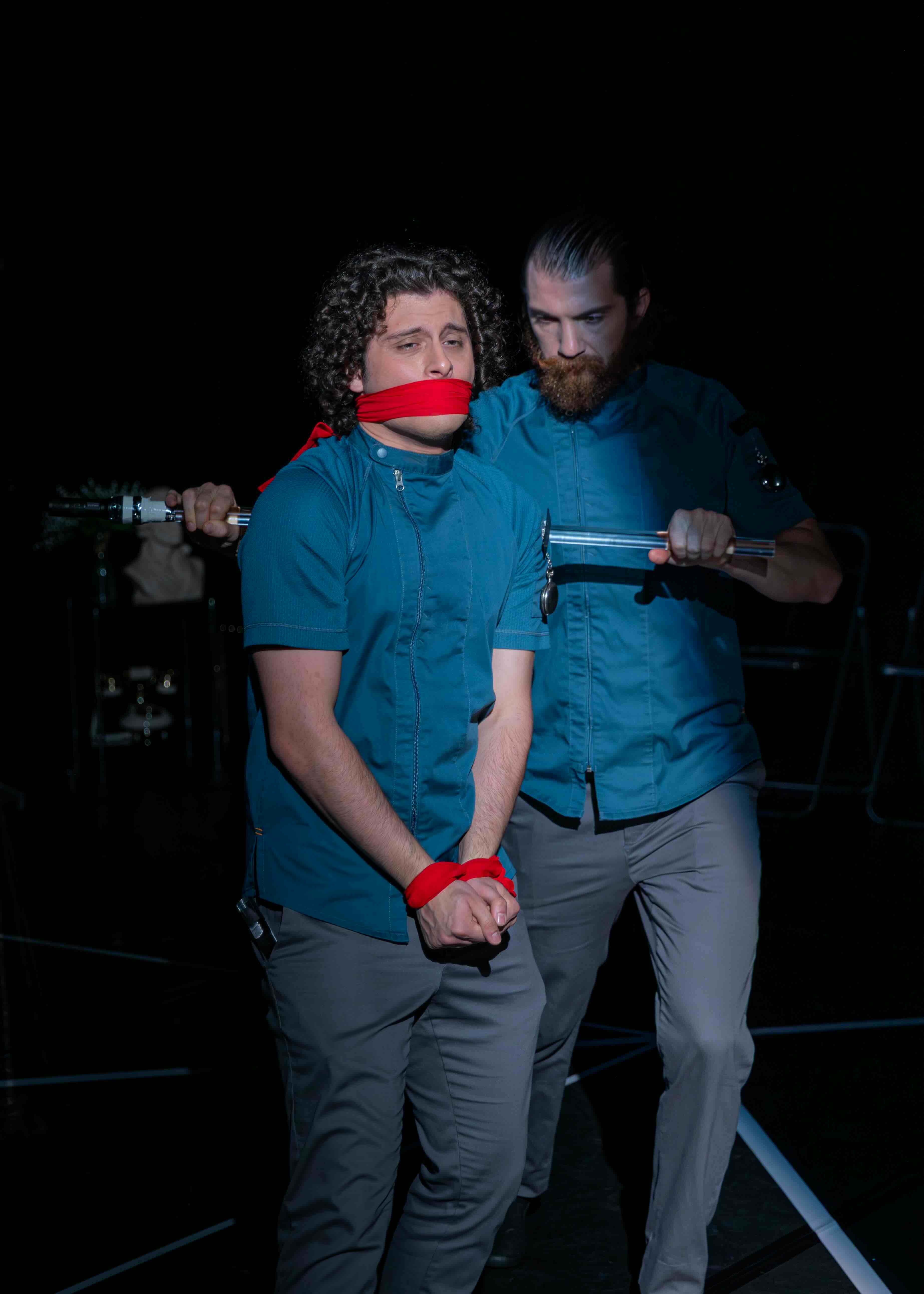  Nathan Reder as Criminal Poet and Ian Cramer as S-4711. 